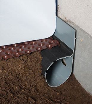 Closeup of a crawl space drainage system installed in Bonaire