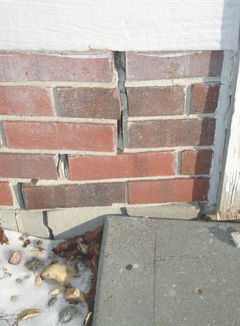Severe street creep damage to a garage wall outside a Mcdonough home