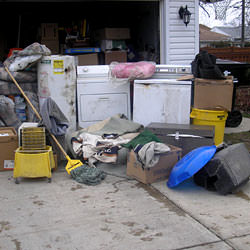 Soaked, wet personal items sitting in a driveway, including a washer and dryer in Summerville.