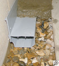 A no-clog basement french drain system installed in Goose Creek